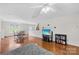 Open-concept living space with hardwood floors, a dining table, and a comfortable seating area at 1023 Valley Ridge Rd, Charlotte, NC 28214