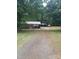 Spacious property with a single-story home, open carport, and large front yard with mature trees at 10500 Bethel Church Rd, Midland, NC 28107