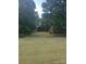 Expansive lawn with mature trees provides a peaceful, secluded setting for this charming property at 10500 Bethel Church Rd, Midland, NC 28107