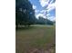 Expansive front yard with lush green grass and mature trees, offering a serene and spacious setting at 10500 Bethel Church Rd, Midland, NC 28107