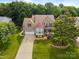 Aerial view of a beautifully landscaped home with mature trees and a long driveway, enhancing curb appeal at 10703 Back Ridge Rd, Charlotte, NC 28277