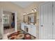 Well-lit bathroom featuring double sinks, a large mirror, and ample storage at 10703 Back Ridge Rd, Charlotte, NC 28277