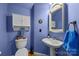 Charming half-bathroom with stylish blue walls, unique mirror and pedestal sink at 10703 Back Ridge Rd, Charlotte, NC 28277