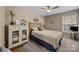 Comfortable bedroom featuring natural light, carpeted floors, a ceiling fan, and stylish decor at 10703 Back Ridge Rd, Charlotte, NC 28277