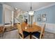 Dining area with blue walls and round table, open to main floor and staircase at 10703 Back Ridge Rd, Charlotte, NC 28277