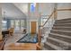 Grand entryway with soaring ceilings, staircase, and views to the formal dining room and living room at 10703 Back Ridge Rd, Charlotte, NC 28277