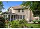 Spacious two-story home exterior with a screened-in porch and manicured landscaping at 10703 Back Ridge Rd, Charlotte, NC 28277