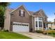 Brick home with a two-car garage, bay window, and well-manicured landscaping at 10703 Back Ridge Rd, Charlotte, NC 28277