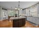 Kitchen with white cabinets, granite countertops, an island, and stainless steel appliances at 10703 Back Ridge Rd, Charlotte, NC 28277