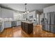 Kitchen with white cabinets, stainless steel appliances, and a dark-colored island at 10703 Back Ridge Rd, Charlotte, NC 28277