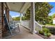 Charming front porch with comfortable rocking chairs and a view of the neighborhood at 10703 Back Ridge Rd, Charlotte, NC 28277