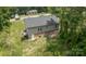 An aerial view of a well-maintained single-Gathering home with a gray roof and green lawn surrounded by trees at 119 Wade Dr, Kings Mountain, NC 28086