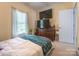 Comfortable bedroom with natural light, dresser and mounted televisions at 119 Wade Dr, Kings Mountain, NC 28086