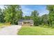 Charming single-Gathering home featuring a cozy front porch, gravel driveway, and lush green lawn at 119 Wade Dr, Kings Mountain, NC 28086