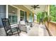Inviting covered front porch with comfortable rocking chairs and ceiling fan at 119 Wade Dr, Kings Mountain, NC 28086
