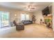 Bright and airy living room featuring a stone fireplace, neutral colors, and plenty of natural light at 119 Wade Dr, Kings Mountain, NC 28086
