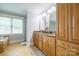 Well-lit bathroom with double sinks, granite countertops, and ample storage in custom wood cabinets at 121 Jefferson Dr, Locust, NC 28097