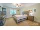 Cozy bedroom featuring neutral carpet, a ceiling fan, and a warm, inviting atmosphere at 121 Jefferson Dr, Locust, NC 28097