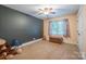 Spacious bedroom with neutral carpet, complemented by a dark accent wall and ample natural light at 121 Jefferson Dr, Locust, NC 28097