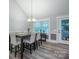 Dining area with wood floors, wainscoting, and modern chandelier at 121 Jefferson Dr, Locust, NC 28097