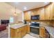 Modern kitchen with stainless appliances, granite countertops, and plenty of cabinet space at 121 Jefferson Dr, Locust, NC 28097