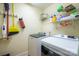 Organized laundry room with modern washer and dryer, complemented by functional storage shelves at 121 Jefferson Dr, Locust, NC 28097