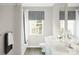 Modern bathroom with double sinks, a large mirror, and stylish window treatments at 12109 Beaux Art Ln, Charlotte, NC 28214
