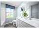 Bathroom featuring a double vanity with chrome fixtures and large mirror at 12109 Beaux Art Ln, Charlotte, NC 28214
