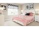Cozy bedroom features pink and white decor, a large window, and elegant bedside lamps at 12109 Beaux Art Ln, Charlotte, NC 28214