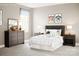 Charming bedroom with neutral walls, a large window, and a dresser with decorative items at 12109 Beaux Art Ln, Charlotte, NC 28214