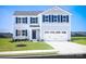 Charming two-story home featuring blue accents, a two-car garage, and a well-maintained front lawn at 12109 Beaux Art Ln, Charlotte, NC 28214