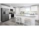 Modern kitchen featuring stainless steel appliances, granite countertops, and an island with barstool seating at 12109 Beaux Art Ln, Charlotte, NC 28214