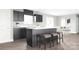 Stylish kitchen featuring dark cabinetry, stainless steel appliances, and a center island with barstool seating at 12109 Beaux Art Ln, Charlotte, NC 28214