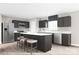 Modern kitchen with dark cabinets, stainless steel appliances, and a stylish island with seating at 12109 Beaux Art Ln, Charlotte, NC 28214