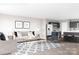 Open-concept living room flows into kitchen with dark cabinets, stainless steel appliances, and a center island at 12109 Beaux Art Ln, Charlotte, NC 28214