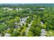 An aerial view showcasing a neighborhood enveloped in mature trees and lush greenery at 122 Pratt St, Belmont, NC 28012