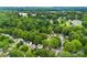A sprawling aerial view of a neighborhood surrounded by lush greenery and mature trees at 122 Pratt St, Belmont, NC 28012