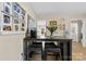 Dining area with a wooden table, stools, a view of the backyard, and a photo collage on the wall at 122 Pratt St, Belmont, NC 28012