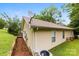 Home exterior featuring neutral vinyl siding, manicured landscaping, and lush greenery at 122 Pratt St, Belmont, NC 28012