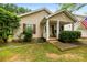 Inviting single-story home with well-kept landscaping, a cozy porch, and decorative shutters for a welcoming curb appeal at 122 Pratt St, Belmont, NC 28012