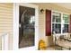 Welcoming front porch featuring a storm door, red shutters, exterior lighting, and comfortable seating, offering an inviting entrance at 122 Pratt St, Belmont, NC 28012