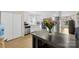 Cozy kitchen showcasing white cabinets, stainless steel appliances, and modern fixtures with an island and natural light at 122 Pratt St, Belmont, NC 28012