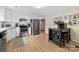 Well-lit kitchen with stainless steel appliances, sleek white cabinets, and a modern island with seating, perfect for cooking at 122 Pratt St, Belmont, NC 28012