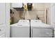 Functional laundry room with a washer, dryer, shelving, and overhead storage space at 122 Pratt St, Belmont, NC 28012