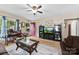Inviting living area with a floral arrangement, entertainment center, and a view of the front yard through the windows at 122 Pratt St, Belmont, NC 28012