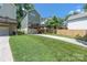 Spacious backyard featuring a well-maintained lawn, lush greenery, and a long driveway to the garage at 12220 Huntersville Concord Rd, Huntersville, NC 28078