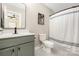 Modern bathroom featuring a stylish vanity with a black faucet and gray tiling at 12220 Huntersville Concord Rd, Huntersville, NC 28078