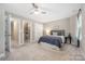 Comfortable bedroom featuring a ceiling fan, closet, and ensuite bathroom at 12220 Huntersville Concord Rd, Huntersville, NC 28078
