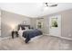 Comfortable bedroom featuring a ceiling fan, access to backyard, and neutral decor at 12220 Huntersville Concord Rd, Huntersville, NC 28078