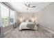 Bright bedroom featuring neutral walls, plush carpeting, and a stylish ceiling fan at 12220 Huntersville Concord Rd, Huntersville, NC 28078